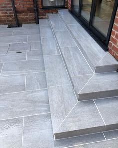 an outdoor patio with steps leading up to the door