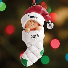 a personalized ornament hanging from a christmas tree