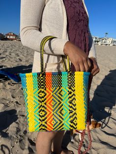 "This beautiful hand-woven, small tote is the latest creation of my business parter Cupertino. Handcrafted in Mexico. 9 1/2\"L x 9 1/2\"H x 5\"D; 16\" H with straps." Yellow Woven Shoulder Bag With Double Handle, Yellow Woven Shoulder Bag For Market, Multicolor Woven Shoulder Bag For Summer, Summer Multicolor Woven Shoulder Bag, Yellow Bags With Braided Handles For Market, Yellow Handwoven Shoulder Bag For Shopping, Business Partners, Sun Valley, Business Partner