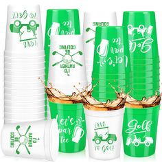 green and white cups with golf related designs on them are stacked in front of each other