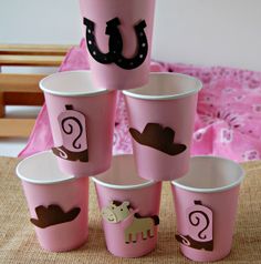 pink cups with cowboy themed designs on them