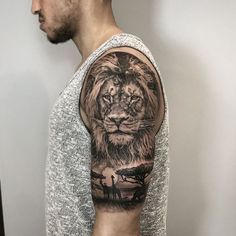 a man with a lion tattoo on his arm