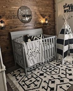 a baby's room decorated in black and white