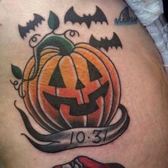 a halloween pumpkin tattoo on the thigh