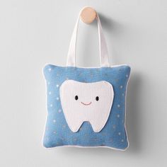 a tooth pillow hanging on the wall