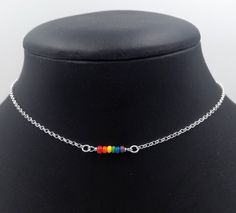 "Handmade sterling silver necklace. Dainty acrylic beads making up the LGBTQ pride flag. Delicate silver chain. Order at least 2.5 cm (1\") longer than the intended wearers neck for a tight fit. Longer for a looser fit. Matching bracelet: https://www.etsy.com/listing/992071278 Necklace and bracelet set (lower price): https://www.etsy.com/listing/1014326575 This is is a made to order listing and you'll get a necklace like the one in the pictures, not the exact copy in the pictures. Please contact Rainbow Choker Jewelry As A Gift, Rainbow Choker Jewelry As Gift, Rainbow Choker Necklace As A Gift, Rainbow Choker Necklace As Gift, Handmade Minimalist Rainbow Jewelry, Silver Charm Necklace With Tiny Beads For Gift, Multicolor Sterling Silver Beaded Necklaces For Gifts, Adjustable Rainbow Sterling Silver Jewelry, Multicolor Sterling Silver Beaded Necklace For Gift