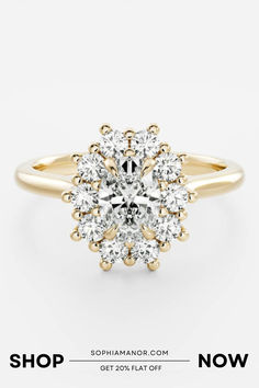 a yellow gold ring with an oval cut diamond surrounded by smaller round diamonds, and the words shop now