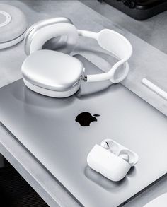 an apple product with headphones on top of it