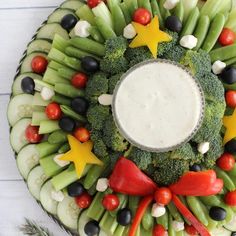 a platter filled with vegetables and dip