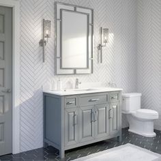 a bathroom with a toilet, sink and mirror next to a white rug on the floor