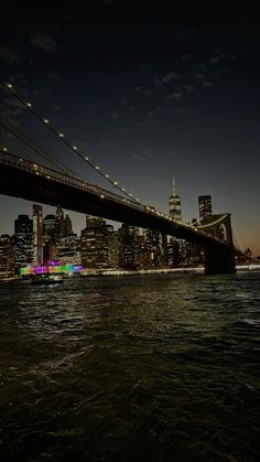 the brooklyn bridge is lit up at night