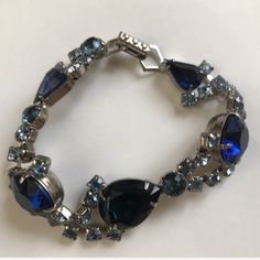 This Bracelet Is Absolutely Stunning! Pictures Do Not Do It Justice! - Perfect Condition - Dark And Light Blue Varying Crystals (Teardrop, Circular, Square) W Silver - Silver Hinge Clasp - Bracelet Missing No Stones, No Scratches (Never Worn) Blue Crystal Bracelets For Formal Occasions, Blue Round Crystal Bracelet For Formal Occasions, Blue Crystal Bracelet For Formal Occasions, Blue Sparkling Stones Bracelet For Formal Occasions, Handmade Blue Jewelry For Evening, Formal Blue Round Crystal Bracelet, Vintage Blue Jewelry With Jubilee Bracelet, Vintage Blue Bracelet For Formal Occasions, Blue Crystal Bracelets For Anniversary