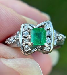 Elevate your jewelry collection with this very unique Vintage Emerald and Diamond Art Deco Style Ring--an exquisite fusion of timeless elegance and Art Deco glamour. This ring is a testament to the opulence of a bygone era, featuring a lush emerald at its center, surrounded by a dazzling array of diamonds, all set in a meticulously crafted Art Deco-inspired design.  Natural emerald weighing .44 carats Natural Diamonds weighing .15 carats.  Size: 6.5 The emerald, with its rich green hue, is a captivating focal point, symbolizing renewal and prosperity. Surrounding this vibrant gemstone are carefully arranged diamonds, adding brilliance and sophistication to the piece. The geometric patterns and intricate detailing of the Art Deco style setting enhance the ring's vintage allure, making it a Art Deco Glamour, Diamond Platinum Ring, Platinum Diamond Rings, Bygone Era, Rich Green, Platinum Ring, Oct 11, Art Deco Inspired, Natural Emerald