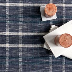 two hot dogs sitting on top of napkins next to each other