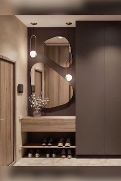 a bathroom with a large mirror on the wall next to a wooden cabinet and shelf