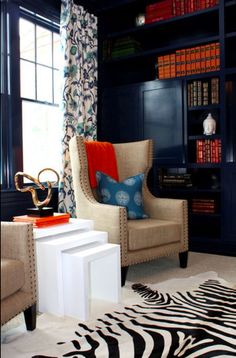 a living room filled with furniture and bookshelves