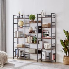 a living room filled with furniture next to a large wall mounted book shelf on top of a wooden floor