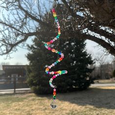 a wind chime hanging from the side of a tree