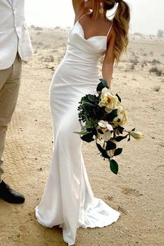 the bride and groom are dancing in the desert