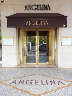 the entrance to an upscale hotel with gold trimming and glass doors that lead into it