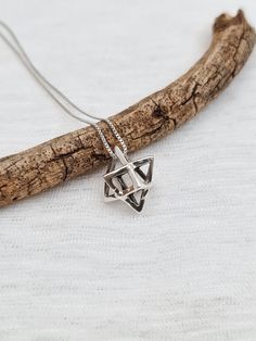 "MERKABA NECKLACE Material: 925 Sterling Silver 925 Sterling silver box chain, spring clasp. Pendant height: 0.65\" Width: 0.5\" The Star Tetrahedron is the energetic and geometric representation of the human body, male and female, heaven and earth, also called the Merkabah. . The word 'Mer' is translated into 'Light', 'Ka' refers to the spirit, while 'Ba' refers to the body or physical being. It is a common belief that the Merkabah is a representation of our energy system's shape in upper dimen Sterling Silver Diamond-shaped Necklace For Gift, Sterling Silver Star Of David For Jewelry Making, Sterling Silver Star Of David Jewelry Gift, Sterling Silver Star Of David Necklace For Anniversary, Sterling Silver Jewelry With Box Chain And Square Pendant, Sterling Silver Star Of David Jewelry Stamped 925, Nickel-free Sterling Silver Star Of David Necklace, Silver Star Of David Necklace With Adjustable Chain, Sterling Silver Box Chain Spiritual Necklace