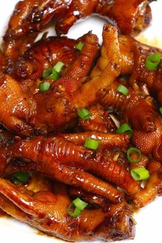 chicken wings with green onions on a white plate