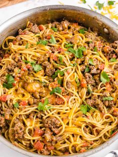 a skillet filled with spaghetti and meat