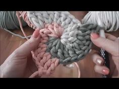 someone crocheting a heart with yarn