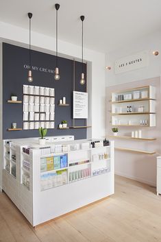 the inside of a beauty store with shelves and lights above it, along with various products on display