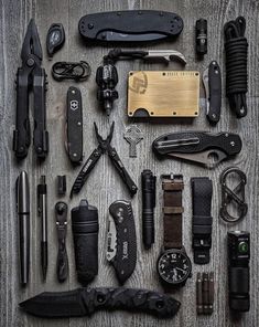 many different types of knifes and knives laid out on a table