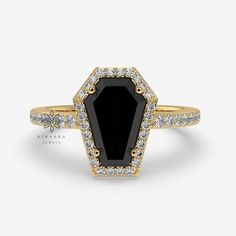 a black and white diamond ring with diamonds on the sides, set in yellow gold