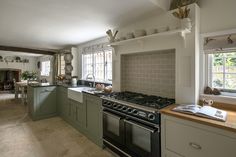 a kitchen with an oven, sink and stove top in it's center island