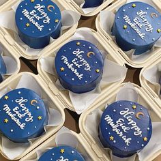 six cupcakes with blue frosting and stars on them in small trays