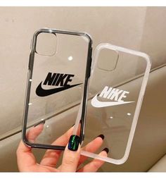 someone is holding up their phone case with the nike logo on it, and there are two other cases next to each other