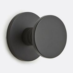 an image of a black door knob on a white wall