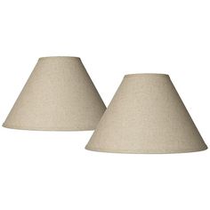 two lamps are sitting next to each other on a white background and one has a beige shade