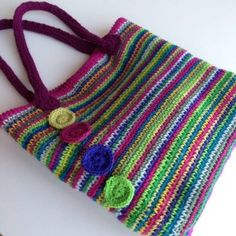 a crocheted purse with two buttons on the front