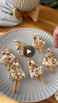 someone is making christmas tree crackers on a plate