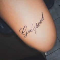 a person with a tattoo on their arm that says, god speed written in cursive writing