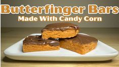 two pieces of cake sitting on top of a white plate with chocolate frosting and the words butterfingerger bars made with candy corn