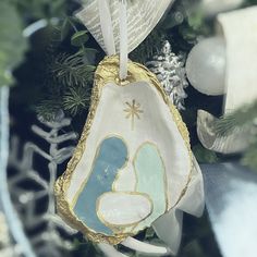 a ceramic ornament hanging from a christmas tree