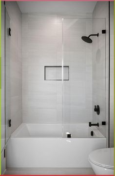 a bathroom with a tub, toilet and shower head