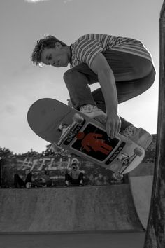 a man flying through the air on top of a skateboard at a skate park