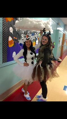 two girls dressed up in costumes posing for the camera