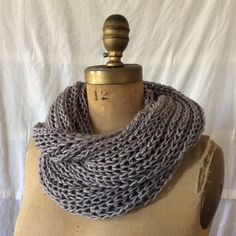 a mannequin wearing a gray knitted scarf