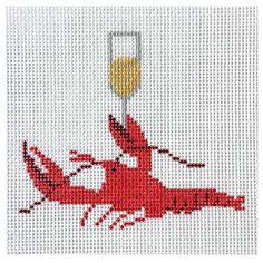 a cross stitch picture of a lobster holding a wine glass in it's mouth