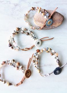 Rustic and elegant. Two delicate strands of quality mixed gemstones, ethical bone beads, shell, mixed metal, Czech beads, and leather with a vintage feel. A mix of beautiful Opal, Fresh Water Pearls, Agate, Quartz, Citrine, Jasper, Coral, and more. Mix in coconut disks, recycled glass, bone disks, Java beads, vintage Czech Glass beads, mixed metals, seed beads, and more. Unique suede leather and coconut shell button closure. Multi 7 strand wire. The item/s pictured is the item you will receive. Adjustable Natural Stones Wrap Bracelet, Bohemian Hand-strung Wrap Bracelet, Everyday Bohemian Hand-strung Wrap Bracelet, Bohemian Agate Beaded Bracelets, Nature-inspired Adjustable Hand-strung Jewelry, Unique Adjustable Beaded Bracelet With Natural Stones, Unique Adjustable Beaded Bracelets With Natural Stones, Bohemian Multi-strand Beige Jewelry, Earthy Hand Wrapped Jewelry For Everyday