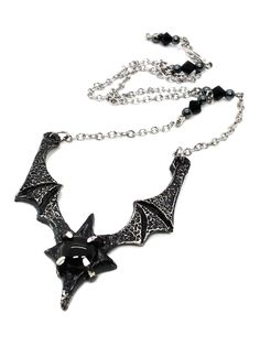 Made to Order! Dramatic, imposing and vampiric as you are, this bat wing necklace will complete your nocturnal ensemble. Stalk the halls of your dwelling or favorite events and capture the attention of your fellow night creatures with its unique design, sculpted in our studio. The pendant is cast in lead free pewter by hand and weathered, then set with a glass or stone cabochon. The chain is accented with hand beaded elements for a finishing touch. It can be layered with one of my rosary chains, Vampire Style Necklaces For Halloween Cosplay, Vampire Style Necklace For Halloween, Black Fantasy Necklaces For Parties, Adjustable Black Vampire Style Necklaces, Adjustable Vampire Necklace For Halloween, Adjustable Black Vampire Necklace, Black Jewelry For Halloween Fantasy Events, Black Gothic Jewelry For Fantasy Events, Black Gothic Necklace For Fantasy Events