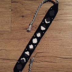 a black and white lanyard with hearts on it