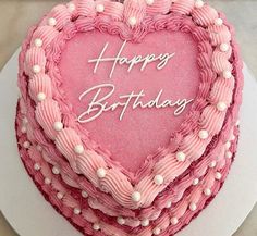 a heart shaped birthday cake with the words happy birthday written on it